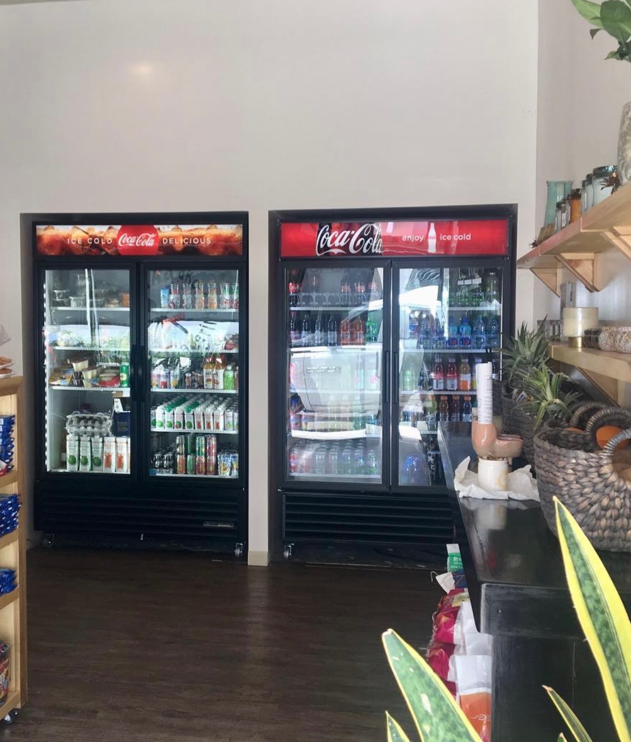 Two stocked refrigerated beverage coolers in the retail store